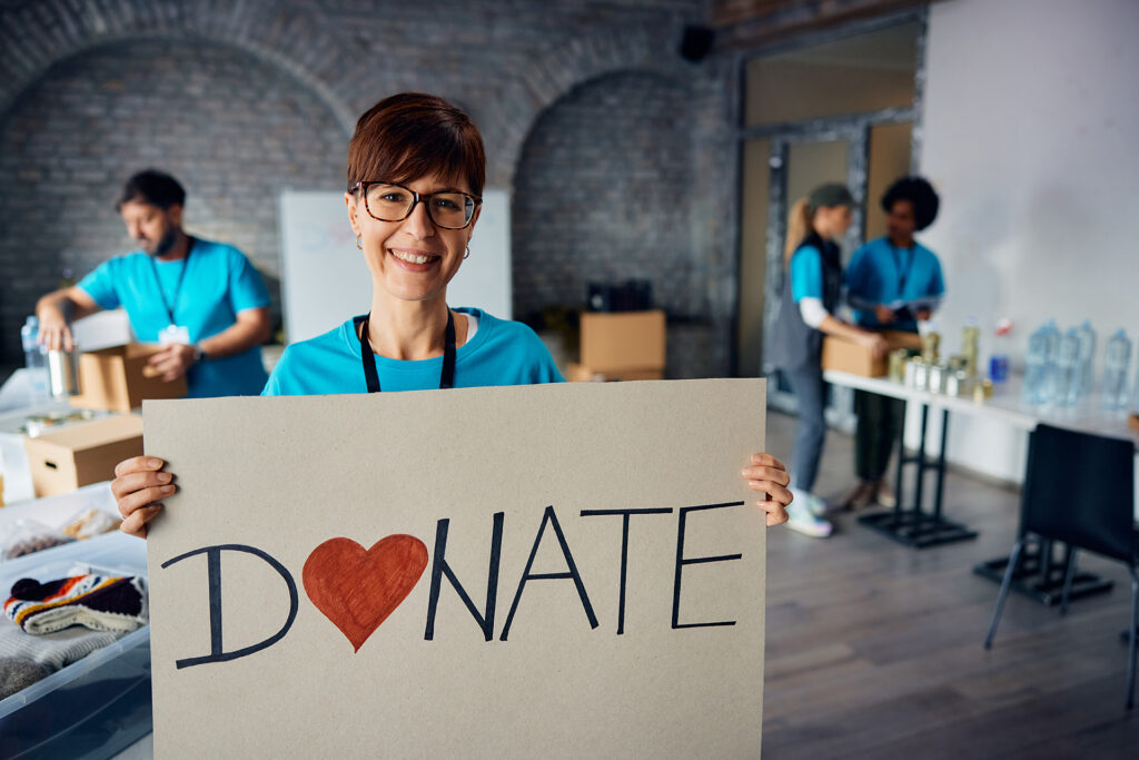 happy-volunteer-holding-placard-with-donate-mess